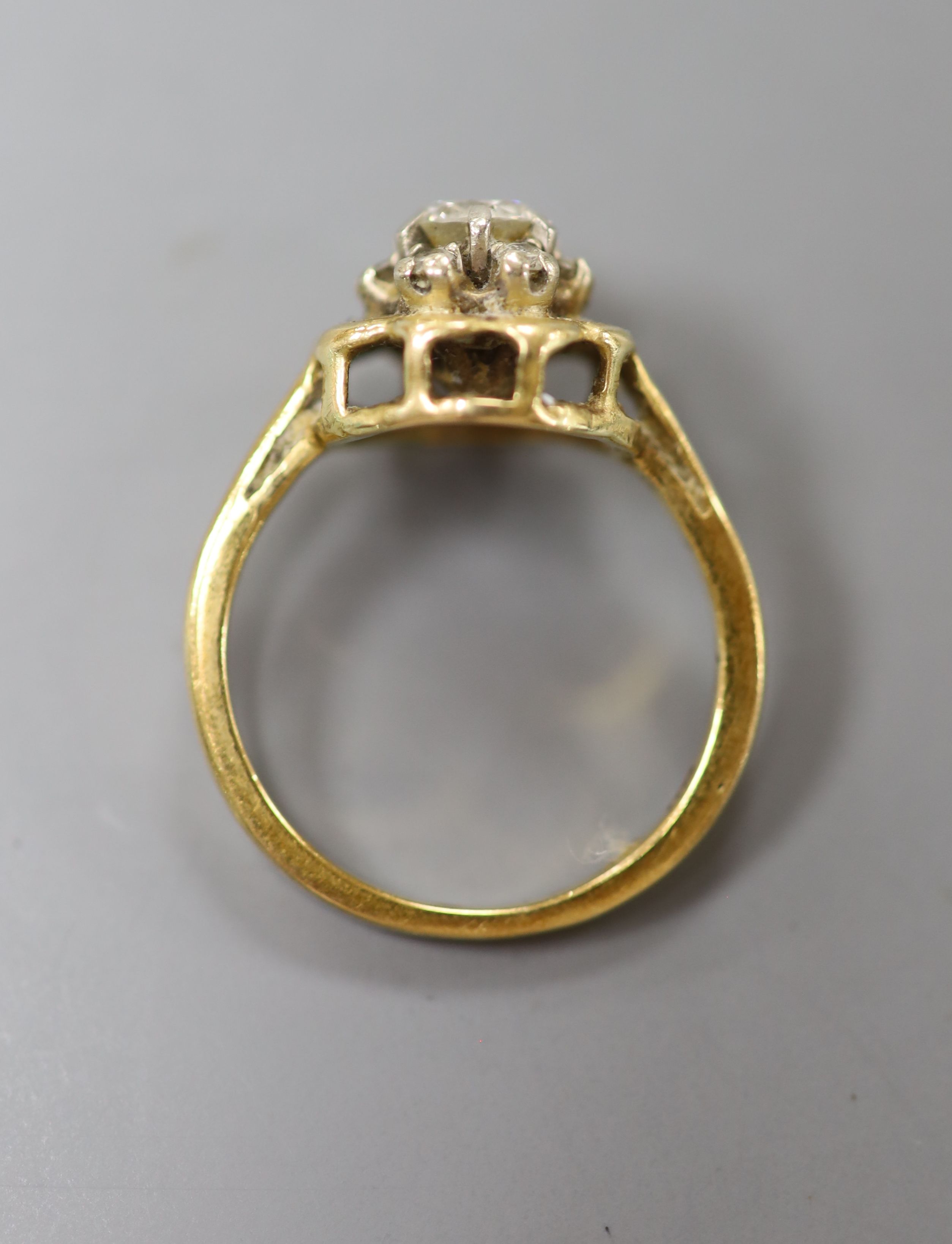 A modern 18ct gold and single stone diamond ring with diamond set border, size L, gross 4 grams.